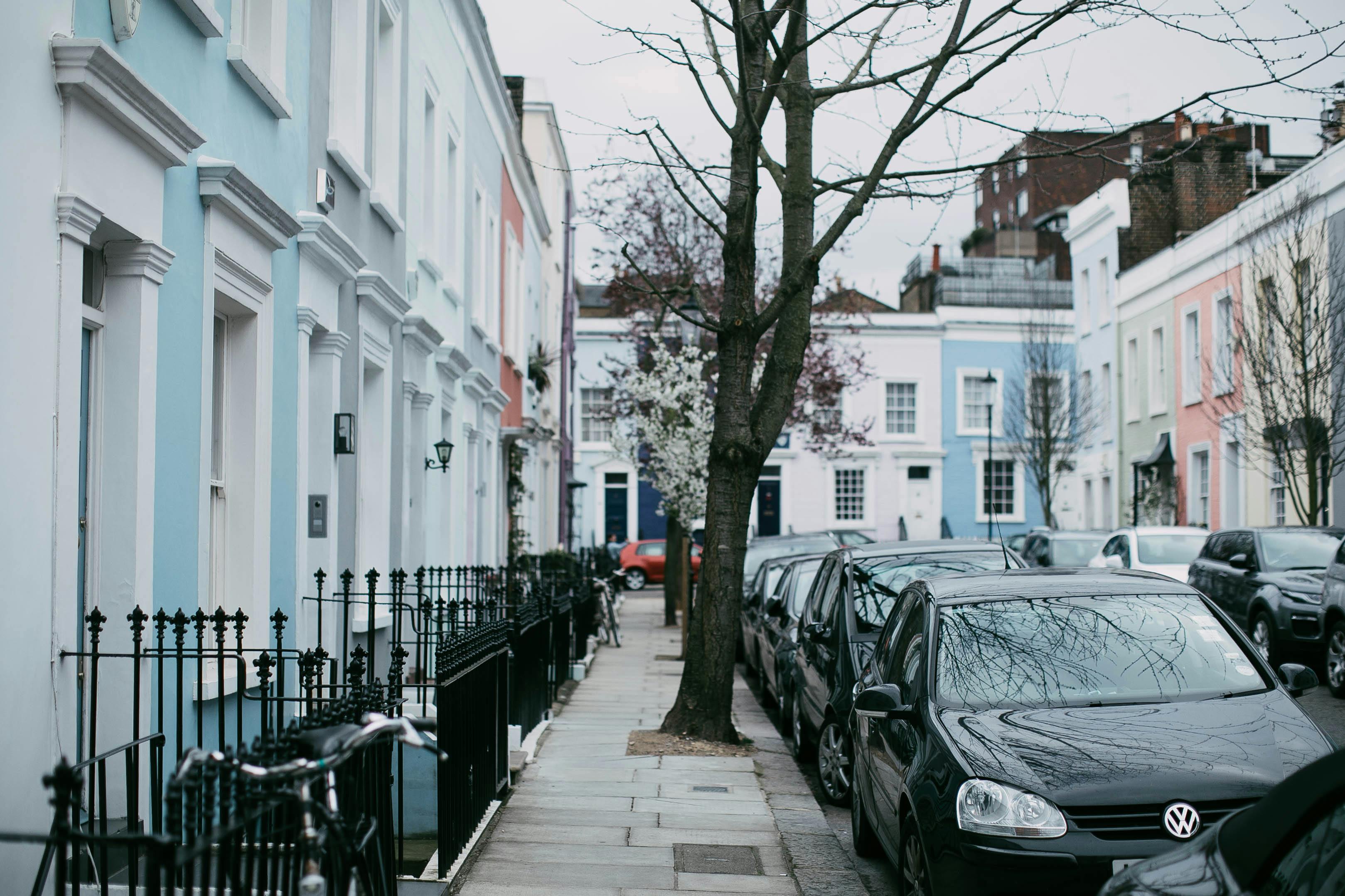 bunch of cars parked on a narrow street